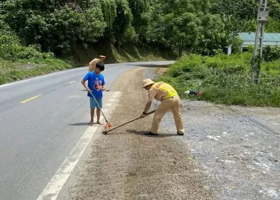 Lào Cai: Cảnh sát giao thông dọn đá trên mặt đường giúp người dân đi lại an toàn