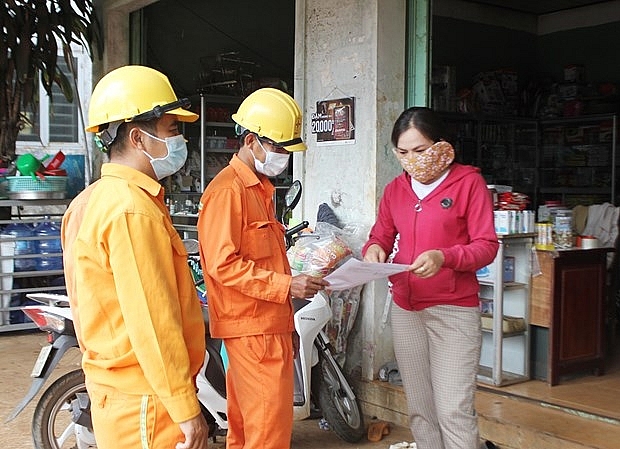 Công nhân ngành điện hướng dẫn người dân về chương trình giảm giá điện, tiền điện