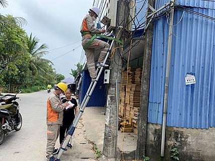 Công nhân Điện lực thay dây dẫn cũ nát bằng dây dẫn điện mới cho khách hàng